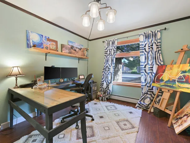 a living room with furniture and a book shelf