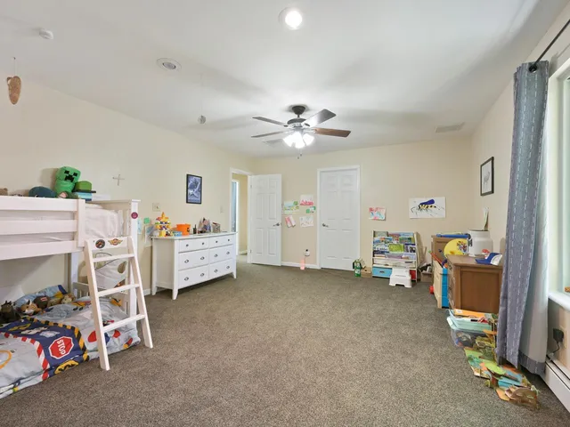a bathroom with a granite countertop toilet sink and mirror