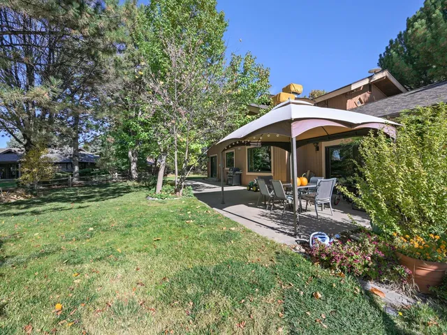 a front view of a house with outdoor seating and plants