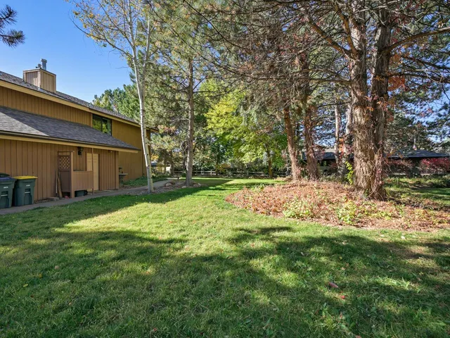 a backyard of a house with table and chairs