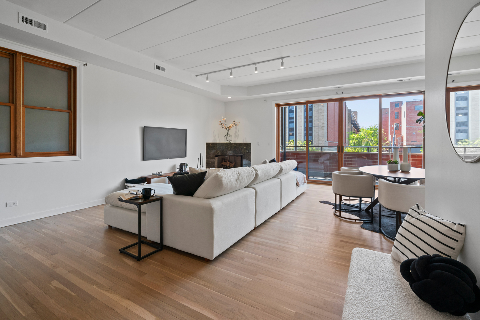 1332 West Madison Street, Unit 2E Chicago, IL 60607 - Photo 7 of 26 a living room with furniture and a flat screen tv