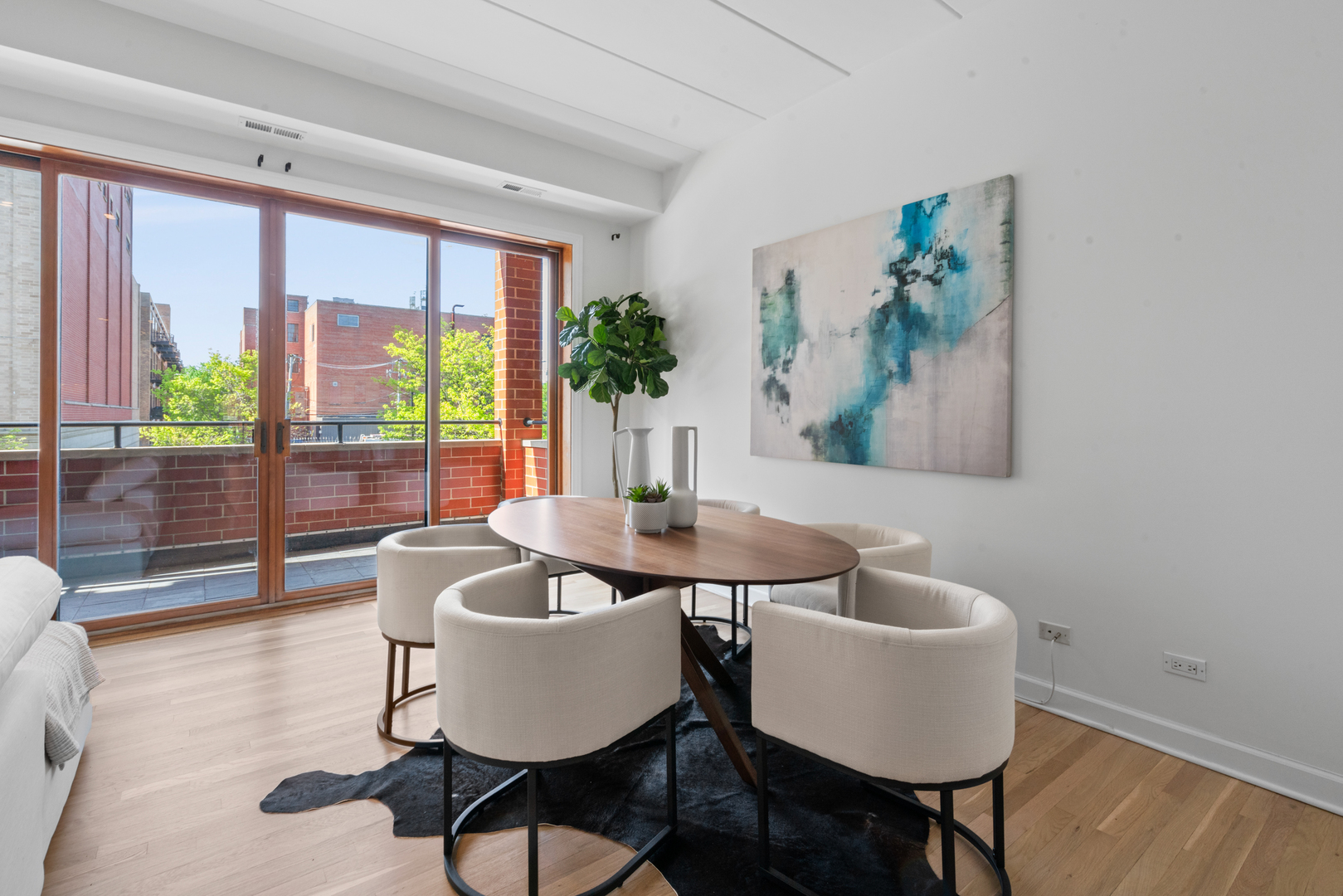 1332 West Madison Street, Unit 2E Chicago, IL 60607 - Photo 10 of 26 a dining room with furniture a rug and wooden floor