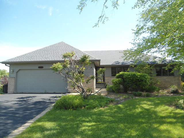 10280 Branch Road Rochelle, IL 61068 - Photo 1 of 17 a front view of a house with a yard and garage