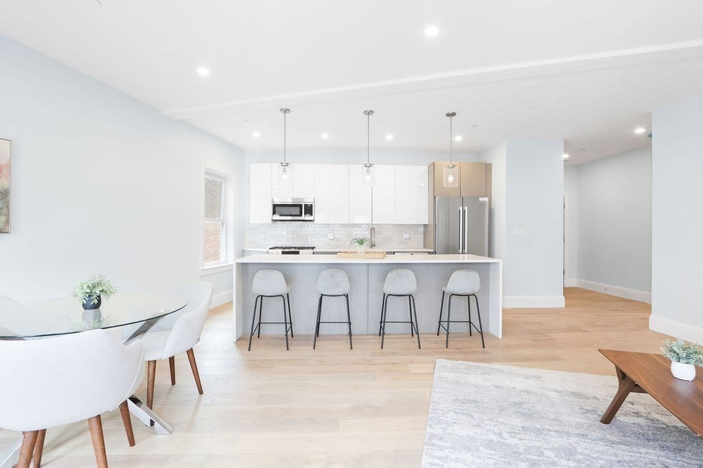 21 Glen Road, Unit 7 Boston, MA 02130 - Photo 3 of 15 a view of kitchen with stainless steel appliances cabinets table and chairs