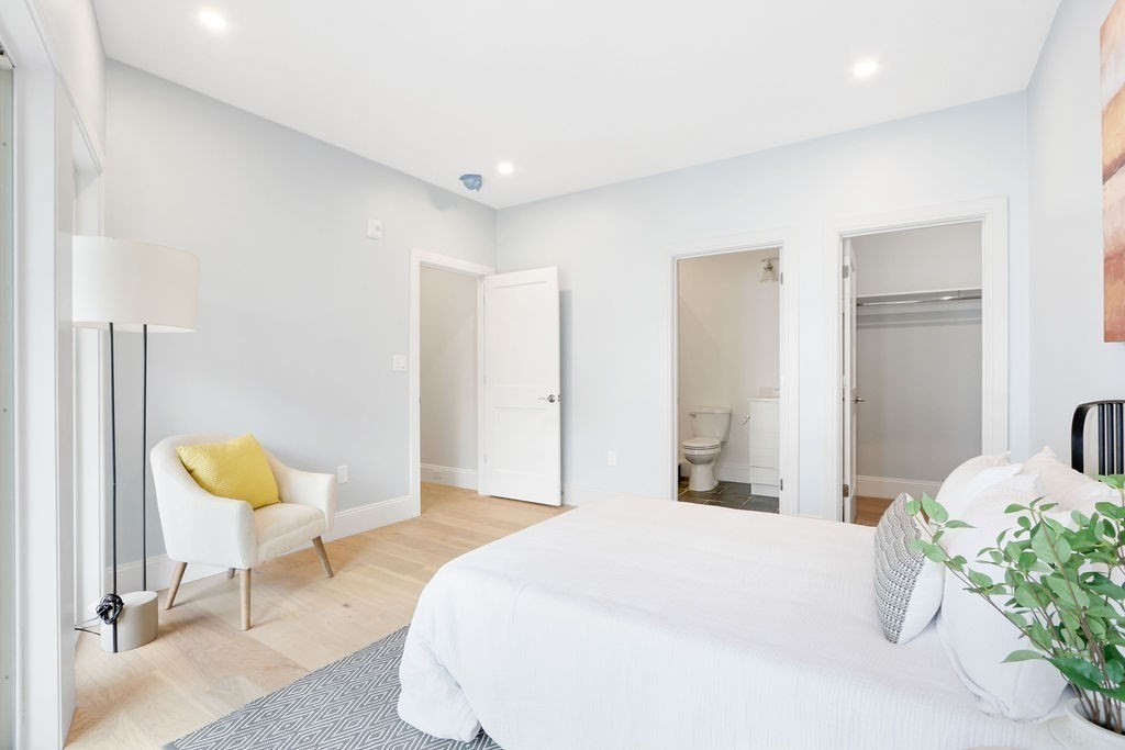 21 Glen Road, Unit 7 Boston, MA 02130 - Photo 7 of 15 a bedroom with a bed and a chair