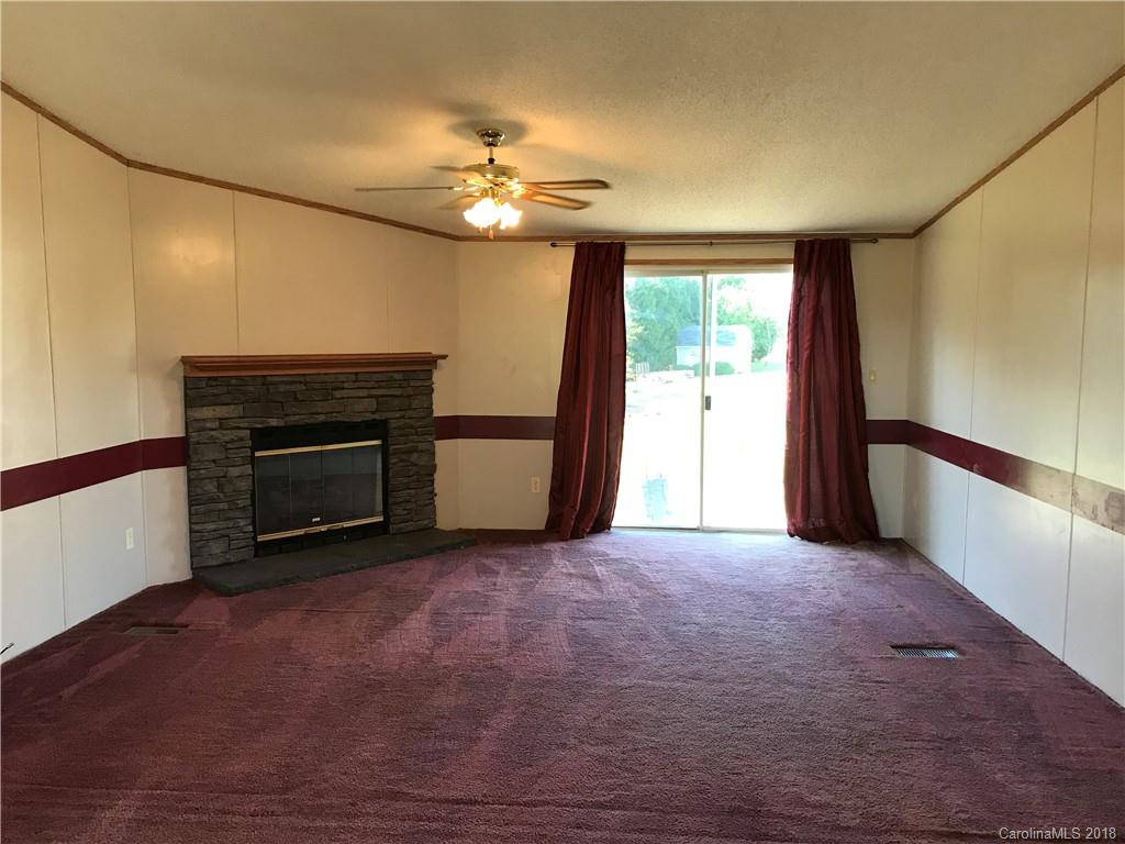 5730 East Bandys Cross Road Catawba, NC 28609 - Photo 4 of 21 a view of empty room with fireplace and fan