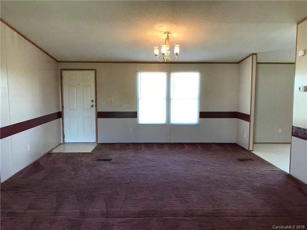 5730 East Bandys Cross Road Catawba, NC 28609 - Photo 6 of 21 an empty room with chandelier fan and windows