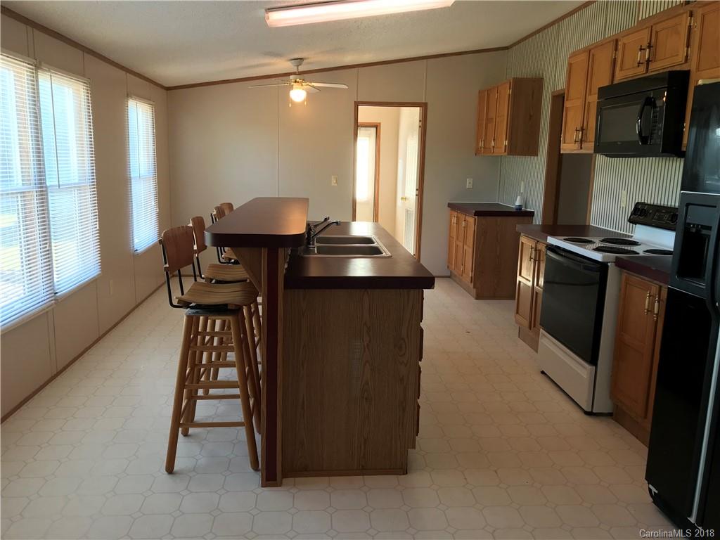 5730 East Bandys Cross Road Catawba, NC 28609 - Photo 7 of 21 a kitchen with stainless steel appliances granite countertop a stove top oven a sink a dining table and chairs