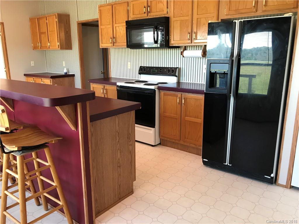 5730 East Bandys Cross Road Catawba, NC 28609 - Photo 9 of 21 a kitchen with stainless steel appliances granite countertop a refrigerator a stove and a sink with wooden cabinets