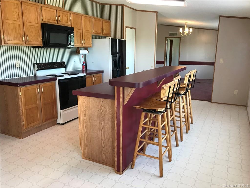 5730 East Bandys Cross Road Catawba, NC 28609 - Photo 10 of 21 a kitchen with stainless steel appliances kitchen island a table chairs microwave and refrigerator