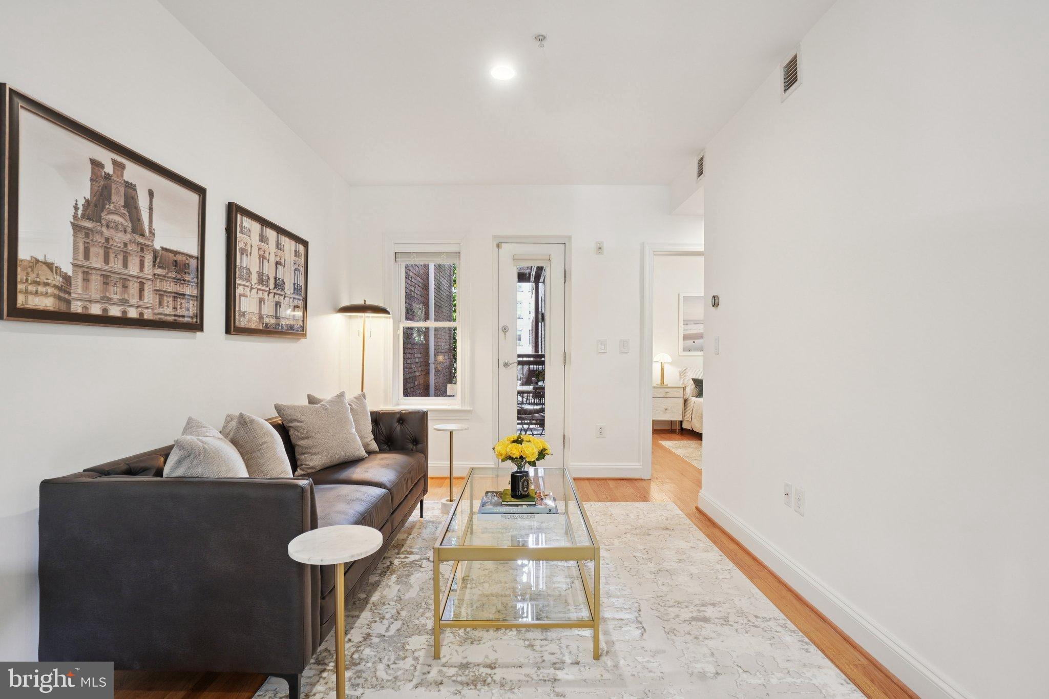 1840 Vernon Street Northwest, Unit 208 Washington, DC 20009 - Photo 11 of 26 a living room with furniture and wooden floor