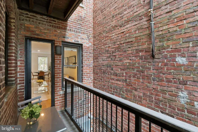 a view of a brick wall from a balcony