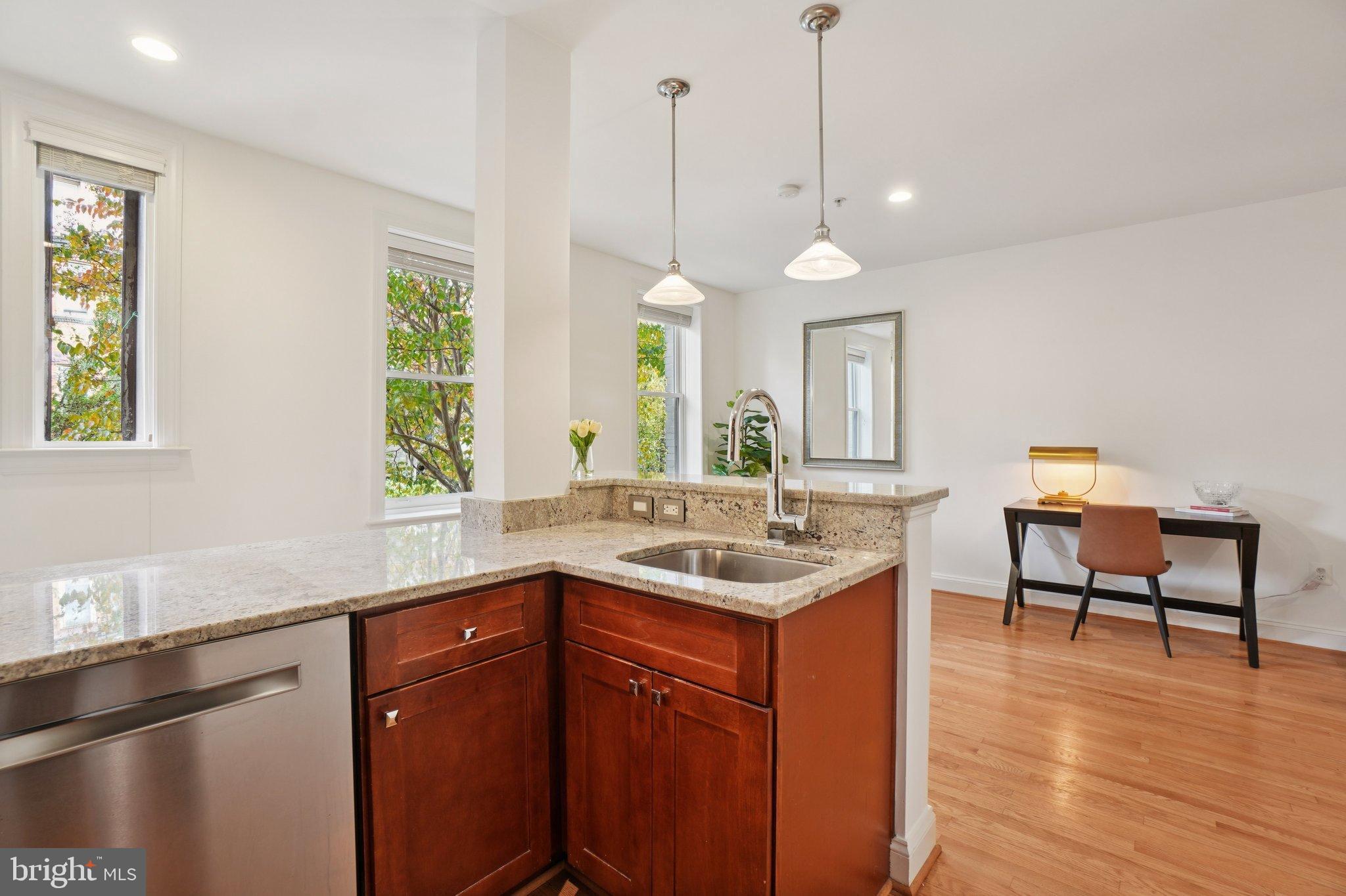 1840 Vernon Street Northwest, Unit 208 Washington, DC 20009 - Photo 16 of 26 a kitchen with a sink a window and chairs