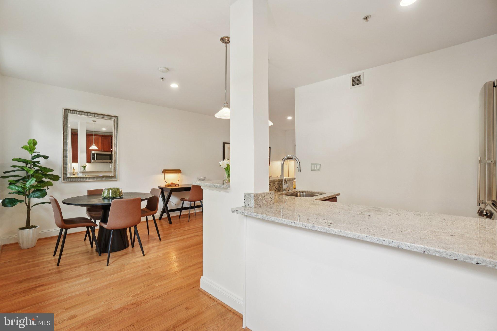 1840 Vernon Street Northwest, Unit 208 Washington, DC 20009 - Photo 20 of 26 a view of dining table chairs and entryway with wooden floor