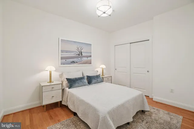 a bedroom with a bed and a painting on the wall