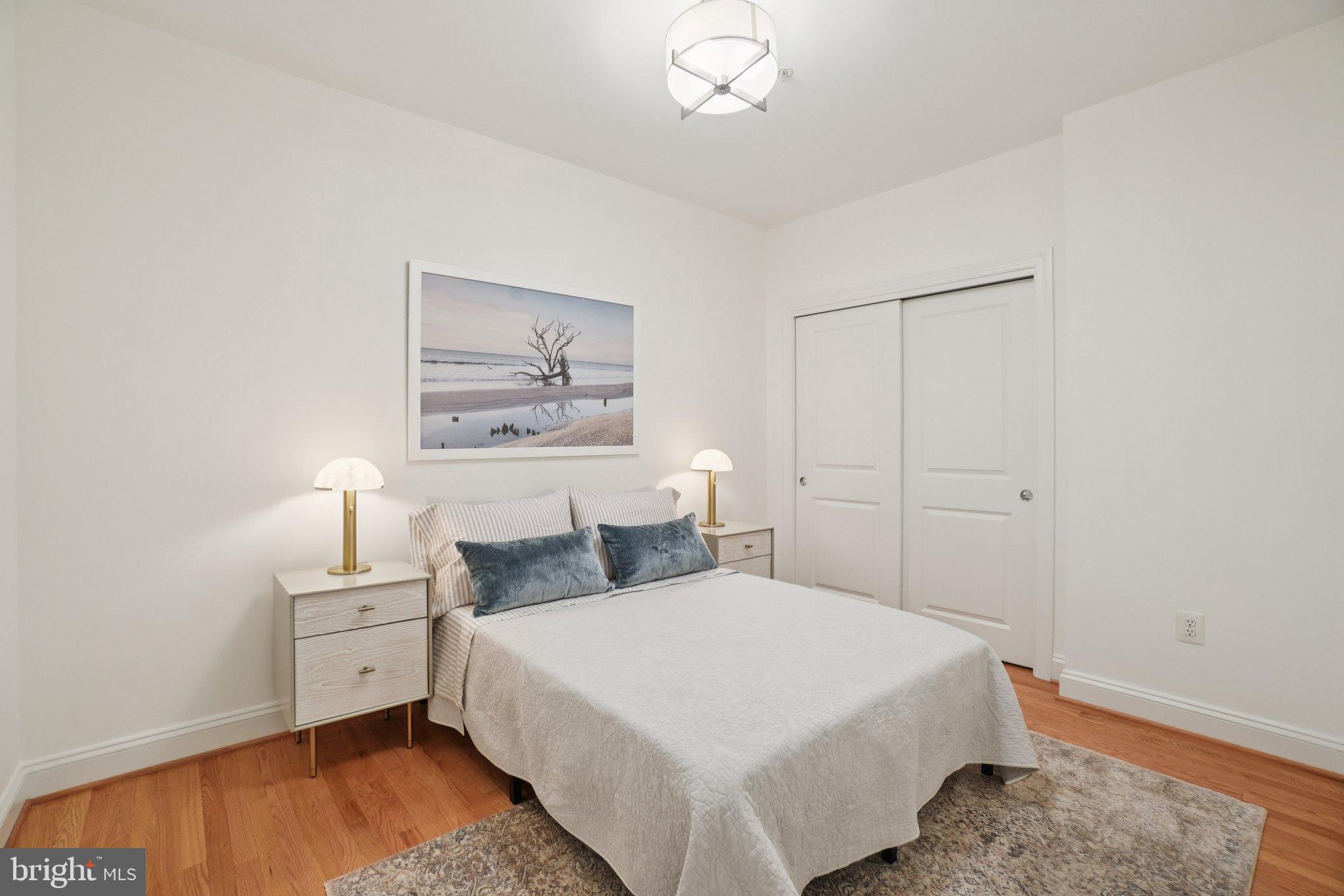 1840 Vernon Street Northwest, Unit 208 Washington, DC 20009 - Photo 21 of 26 a bedroom with a bed and a painting on the wall