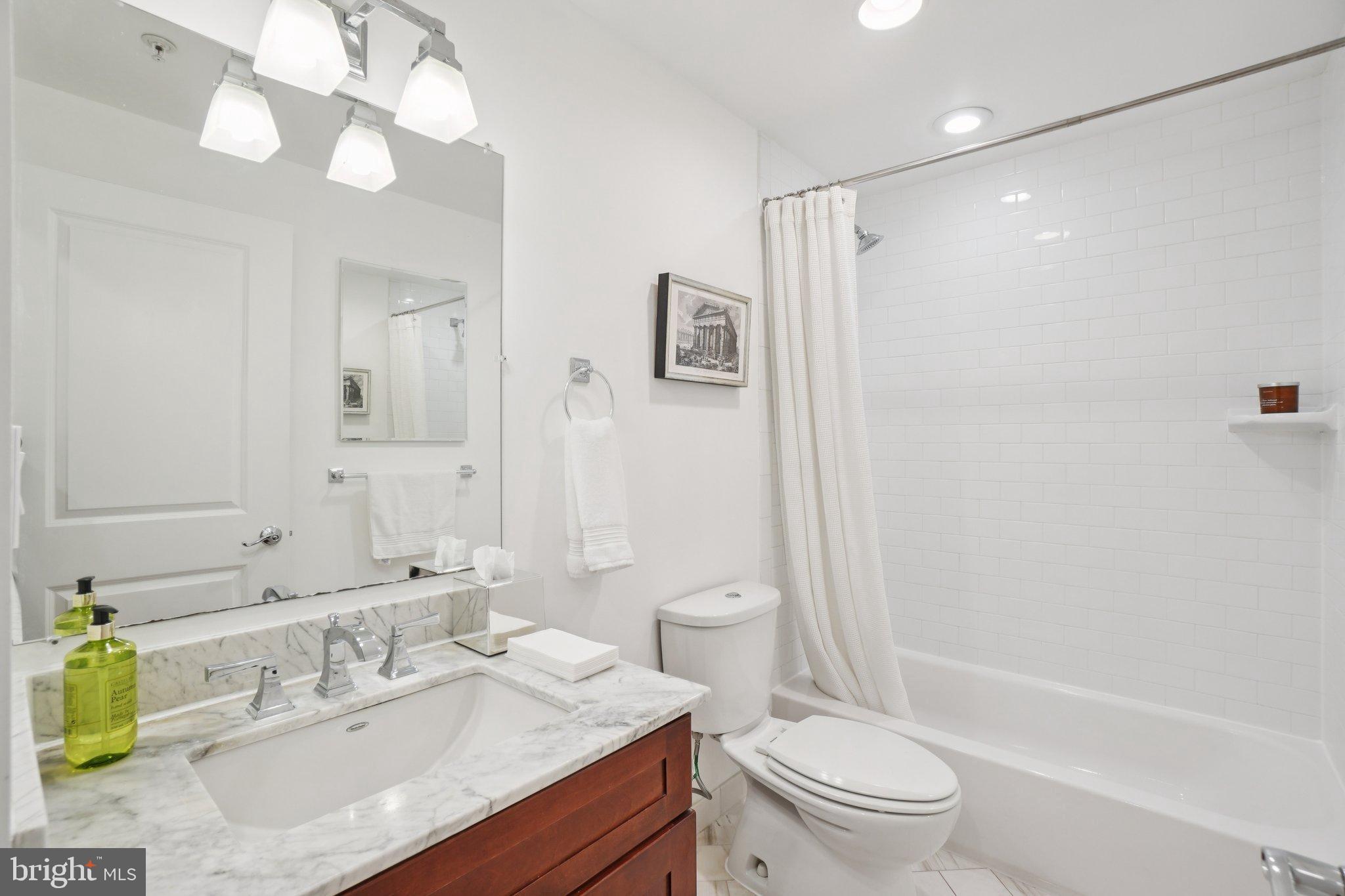 1840 Vernon Street Northwest, Unit 208 Washington, DC 20009 - Photo 24 of 26 a bathroom with a sink a toilet a mirror a vanity and shower