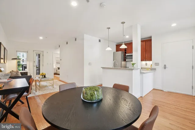 a dining room with furniture and wooden floor