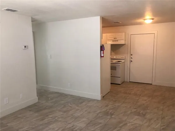 a white refrigerator freezer sitting inside of a kitchen