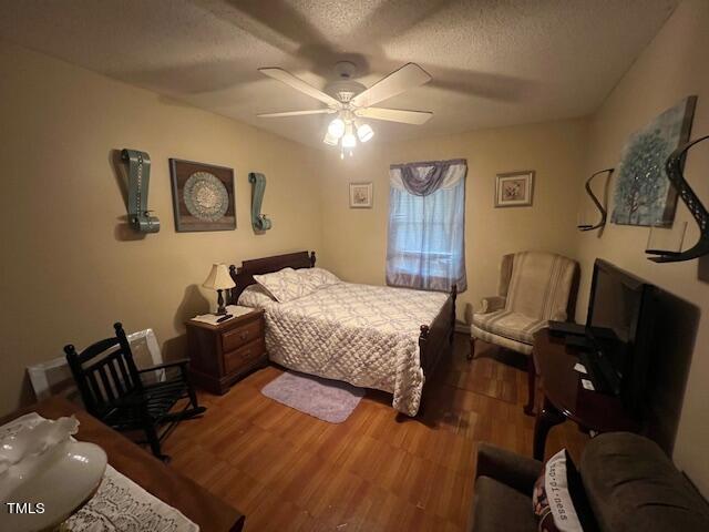 5368 Elevation Road Benson, NC 27504 - Photo 19 of 40 a bedroom with a bed and wooden floor