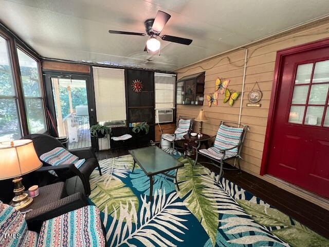 5368 Elevation Road Benson, NC 27504 - Photo 26 of 40 a living room with furniture a floor to ceiling window and a flat screen tv
