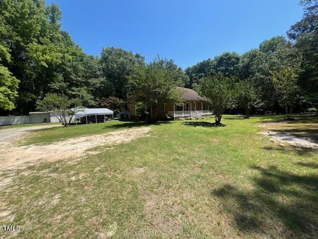 5368 Elevation Road Benson, NC 27504 - Photo 37 of 40 a view of a swimming pool with lawn chairs and plants