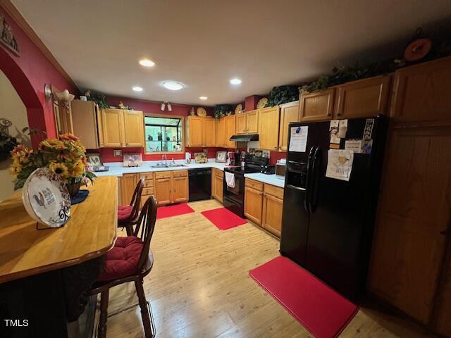 5368 Elevation Road Benson, NC 27504 - Photo 5 of 40 a kitchen with stainless steel appliances kitchen island granite countertop a refrigerator a stove a sink dishwasher with a dining table and chairs