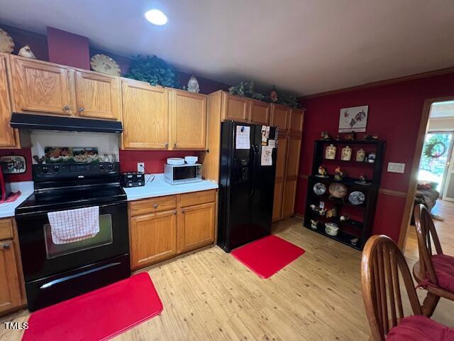 5368 Elevation Road Benson, NC 27504 - Photo 7 of 40 a kitchen with stainless steel appliances granite countertop a refrigerator cabinets and wooden floor