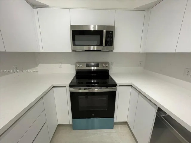 a kitchen with a stove and a microwave