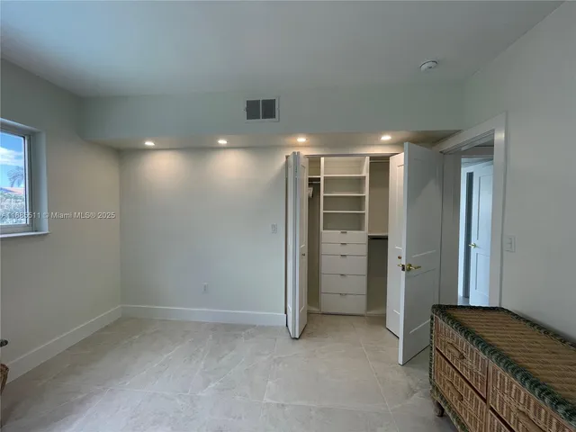 a room with a chair and a cabinet