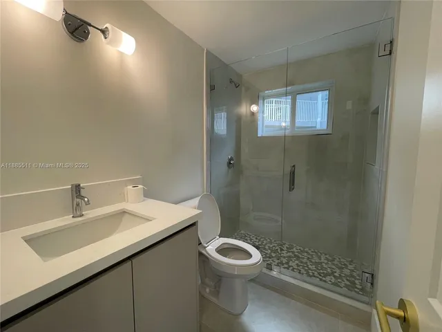 a view of a livingroom with a ceiling fan and window