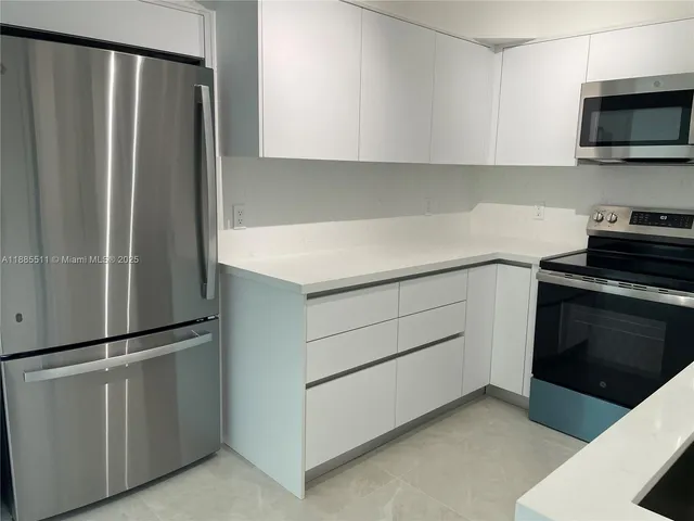 a kitchen with a refrigerator stove and microwave