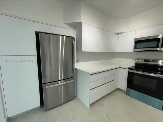 a kitchen with a sink a stove and refrigerator