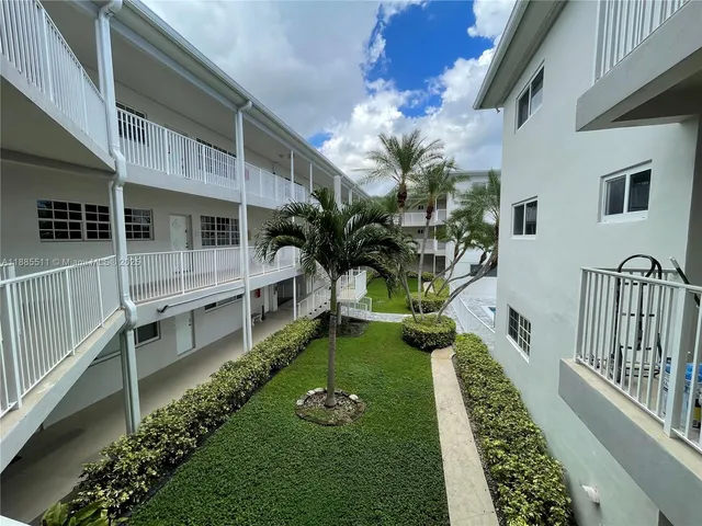 a view of a house with backyard and a swimming pool