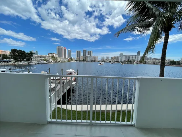 a view of a balcony with a floor to ceiling window and a city view