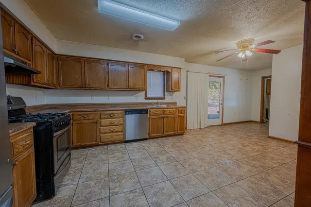 a kitchen with stainless steel appliances granite countertop a stove sink and cabinets