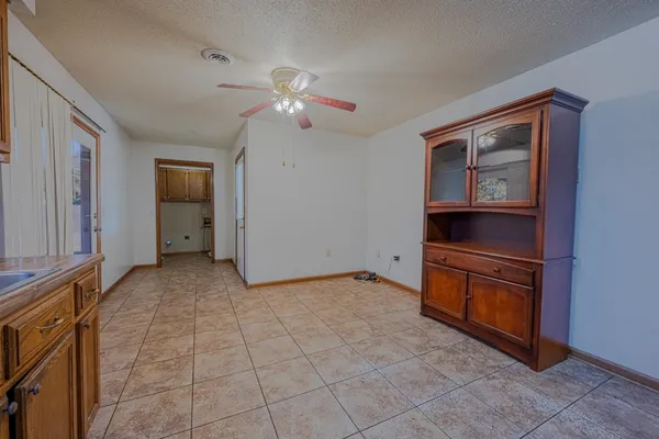 a view of an empty room with closet and a window