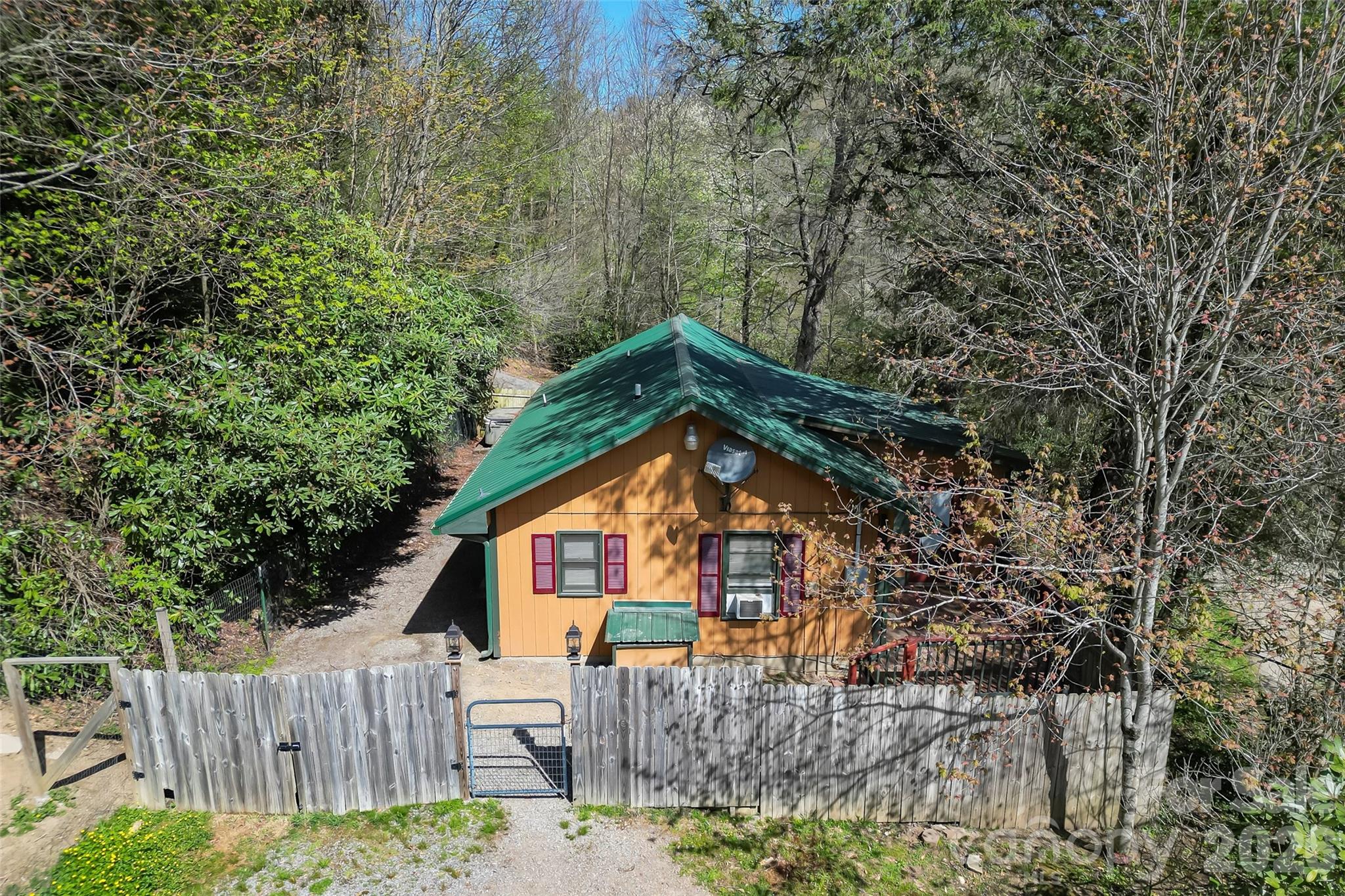 242 Plott Balsam Road Maggie Valley, NC 28751 - Photo 26 of 32 a view of a house with a small yard and large trees