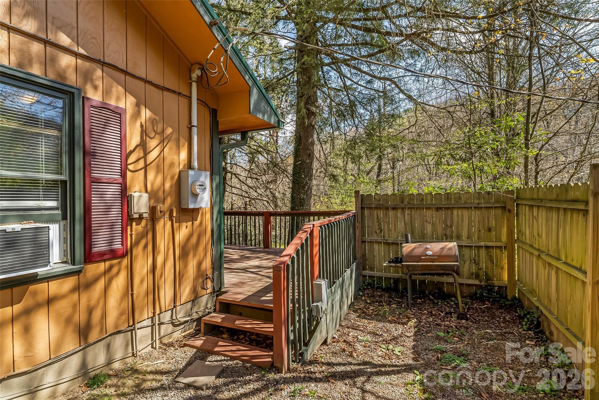 242 Plott Balsam Road Maggie Valley, NC 28751 - Photo 27 of 32 a view of a balcony with wooden floor and iron fence