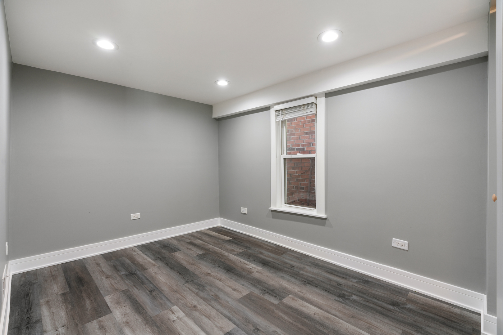 4624 North Springfield Avenue Chicago, IL 60625 - Photo 12 of 44 an empty room with wooden floor and windows