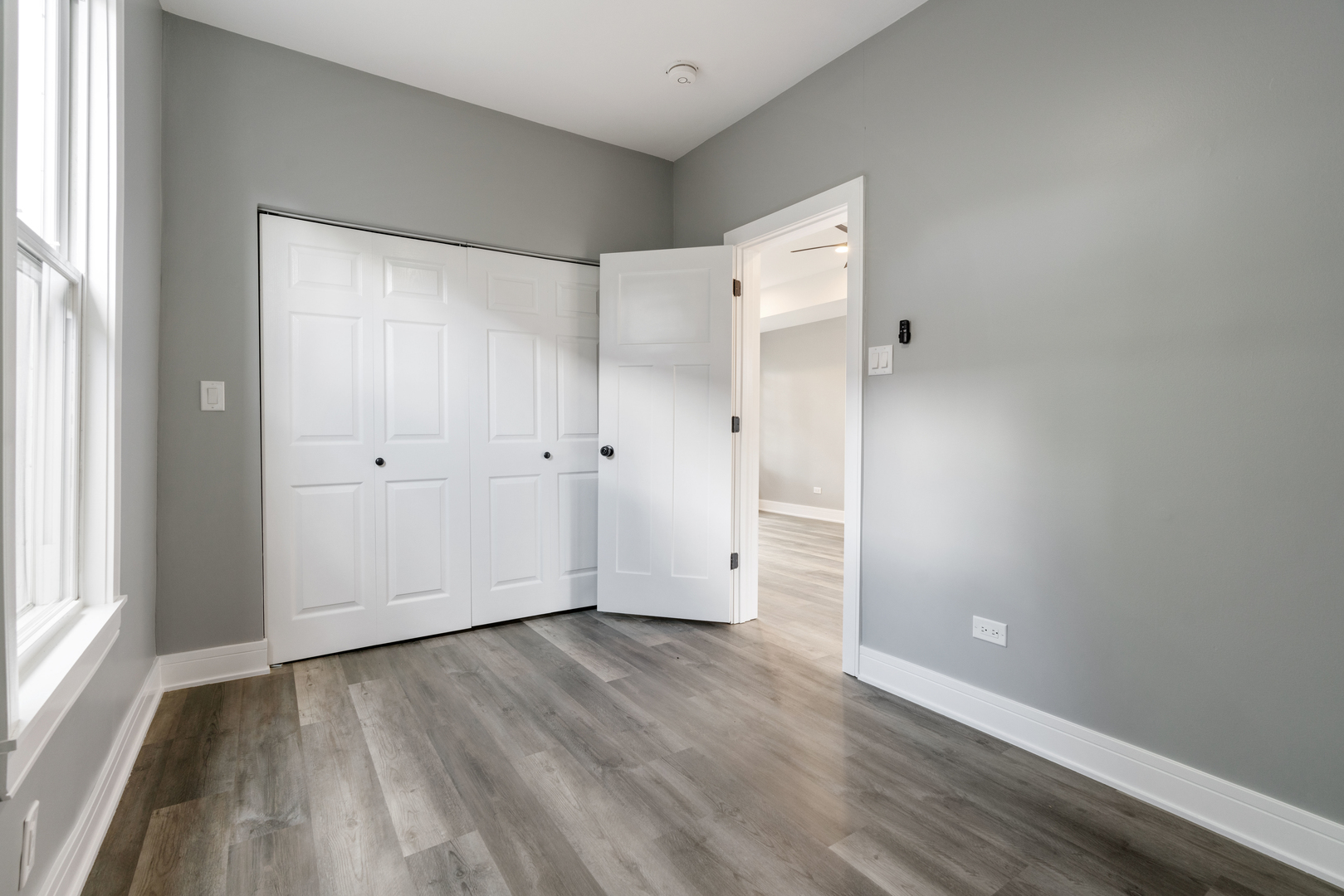 4624 North Springfield Avenue Chicago, IL 60625 - Photo 26 of 44 a view of an empty room with wooden floor and a window