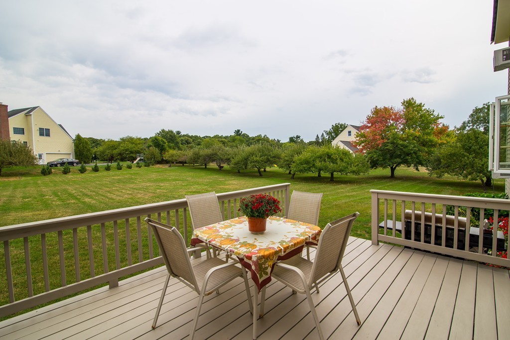 64 Chamberlain Road Westford, MA 01886 - Photo 21 of 27 a view of a balcony with two chairs and a table