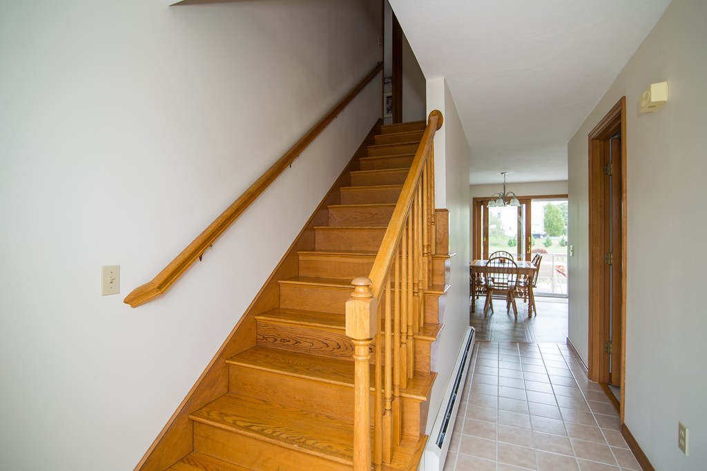 64 Chamberlain Road Westford, MA 01886 - Photo 3 of 27 a view of staircase with lots of frames on wall and a large window