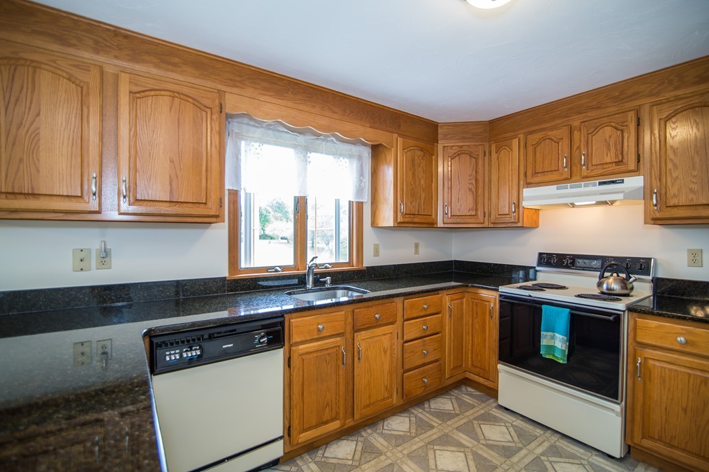 64 Chamberlain Road Westford, MA 01886 - Photo 6 of 27 a kitchen with stainless steel appliances granite countertop a sink stove and cabinets