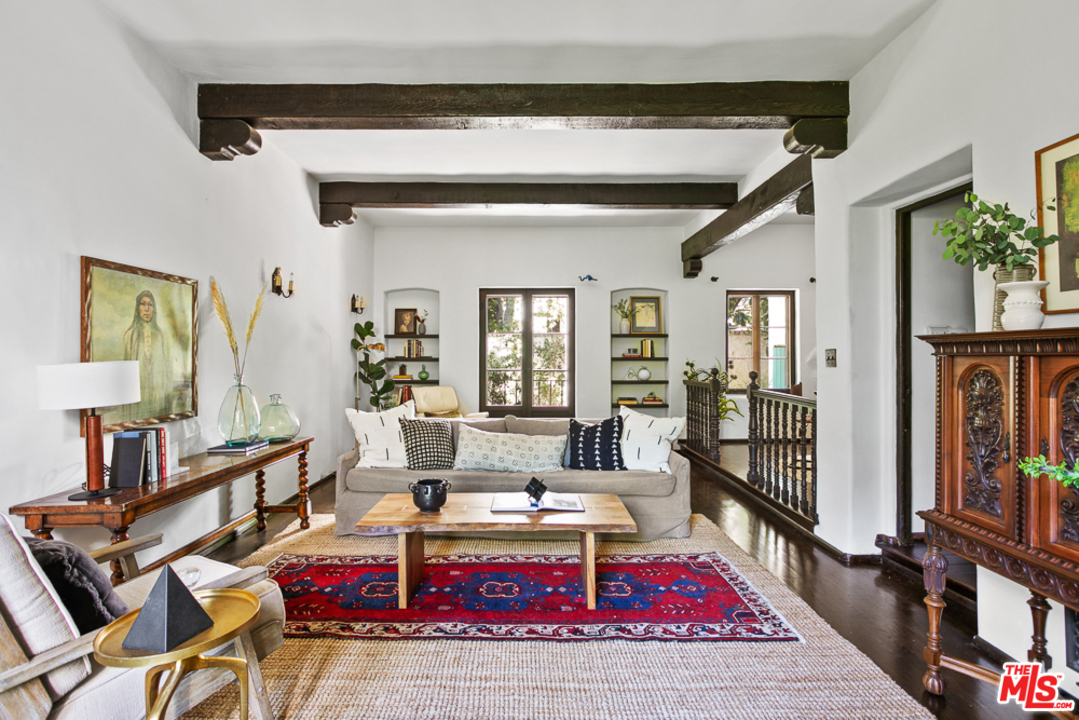a living room with furniture a rug and a window