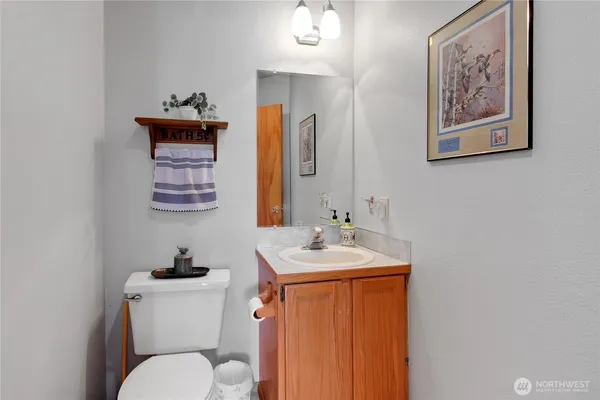 a bathroom with a toilet sink and mirror