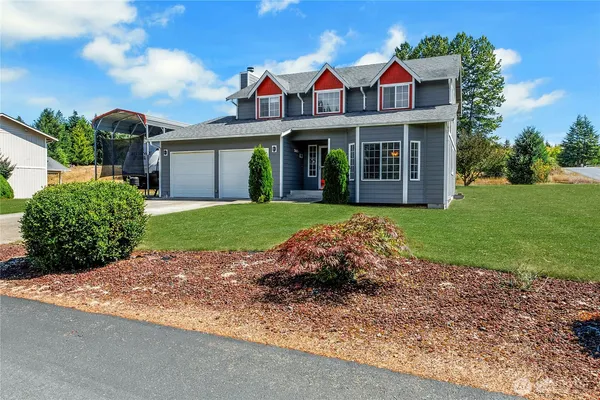 a front view of a house with garden