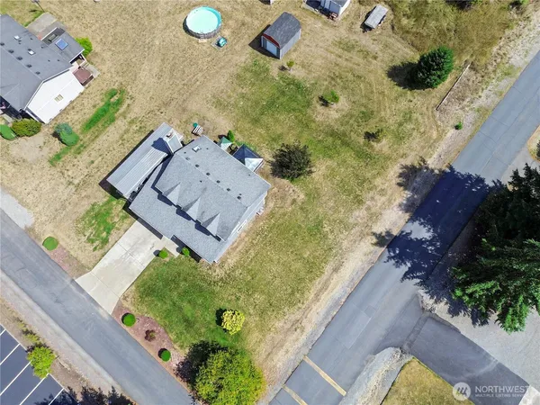 an aerial view of a house with a yard basket ball court and outdoor seating