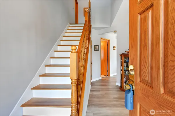 a view of an entryway with wooden floor and staircase