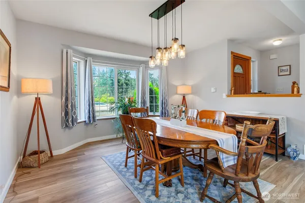 a view of a dining room with furniture wooden floor and chandelier